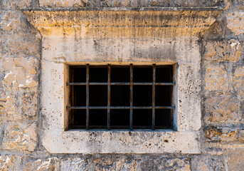 Building's facade. Window with metal bars. Architectural detail. Close-up