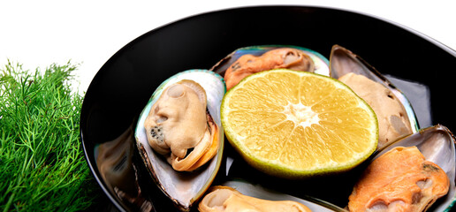 mussels on a platter with lemon on a white background top view