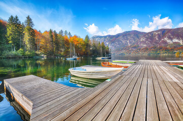 Amazing  view  of  Bohinj Lake with boats during autumn .