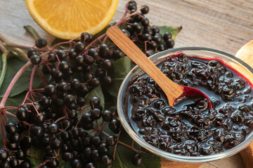 Elderberry jam, fresh berries and leaves and lemon.