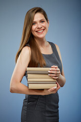 Smiling female teacher or student girl holding books stack isolated portrait.