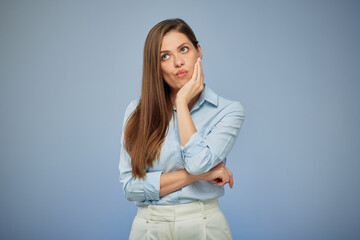 Young woman with toothache isolated portrait on blue. Girl touching cheek.