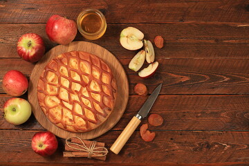 Kitchen background with apple pie, honey, apples, spices, cozy warm concept, hello autumn, hygge style, modern bakery advertisement, selective focus, top view,