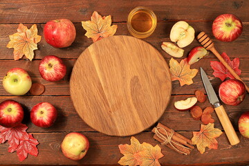 Kitchen autumn background with honey,apples, spices and seasonal flowers and leaves, cozy warm concept, hello autumn, hygge style, selective focus, top view,