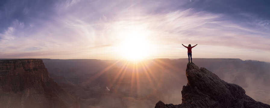 Epic Adventure Composite of Woman Hiker on top of a rocky mountain. Dramatic Sunset Sky. 3d Rendering peak. Background landscape from North America. Freedom Concept.
