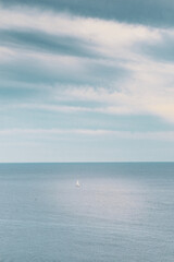 Sailboat in freedom in the middle of the ocean enjoying the immensity and force of nature vertical
