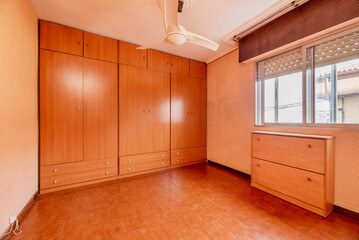 Room with a custom made cherry wood wardrobe covering the entire wall