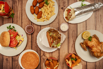 Set of dishes of a kebab restaurant with durum, lamb kebab sandwich, french fries and a burger with cheese and tomato