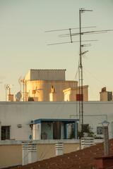 Fototapeta na wymiar City rooftops with chimneys and tv antennas