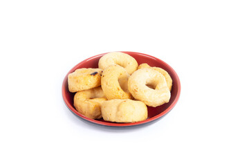 Tarallini or Taralli an Italian Snack Ring or Cracker Isolated on White in a Red Bowl in a Three Quarter or Side View Shot