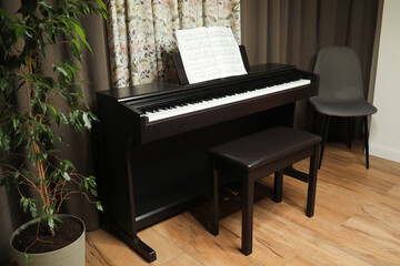 black piano and sheet music, at home