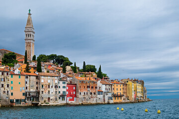 Fototapeta premium Stormy sky provides an artistic canvas for the many hued houses of Rovinj