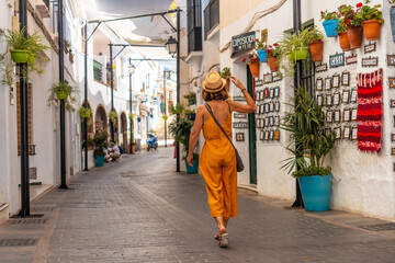 A tourist in the white houses walking and visiting the municipality of Mijas in Malaga. Andalusia - obrazy, fototapety, plakaty