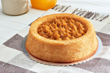 Round churros cake with dulce de leche and cinnamon. Brazilian dessert. Homemade cake in the shape...