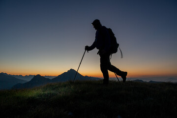 Early morning hiker walking with flashlight on head