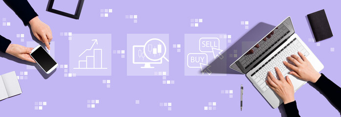 Fototapeta na wymiar Stock trading theme with two people working together