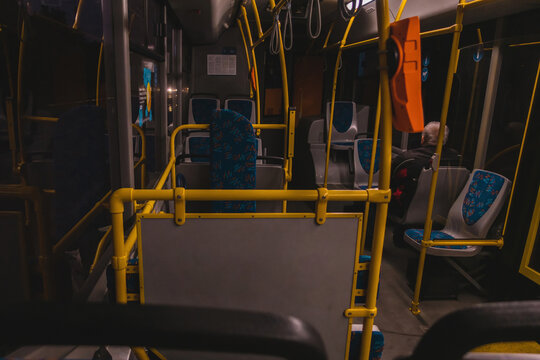 Old Man Sitting Alone In An Empty Public Transport With Many Handrails At Night. Indoors. Public. Transport. Electric. Interior. Passenger. Empty. Subway. Tourist. Inside. Individuality. Safe. Looking