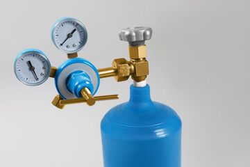 Oxygen tank on light grey background, closeup. Medical equipment