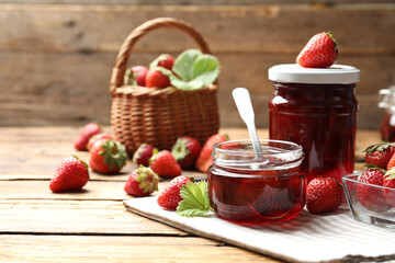 Delicious pickled strawberry jam and fresh berries on wooden table