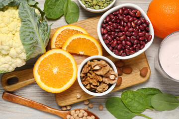 Set of natural food high in calcium on white wooden table, flat lay