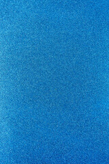 Background with sparkles. Backdrop with glitter. Shiny textured surface. Vertical image. Strong blue