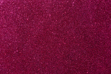 Background with sparkles. Backdrop with glitter. Shiny textured surface. Dark pink