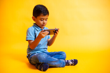 boy sitting looking at his smartphone