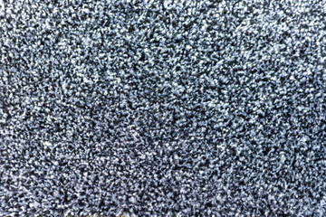 Black and grey carpet texture background closeup view