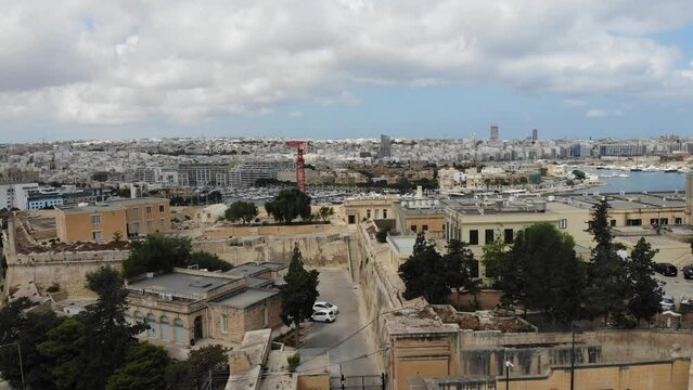 Aerial drone view of Mediterranean streets towards Sliema and Marsamxett Harbour from Floriana, Malta