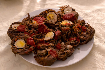 Plate of meat with eggs in it 