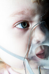 The girl breathes in a mask, pulmonary diseases in children.