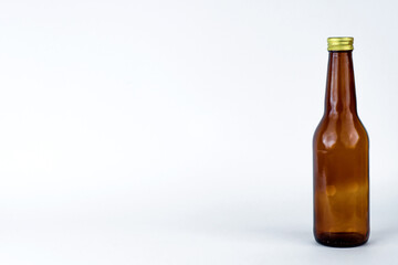 empty brown bottle on the right with white background