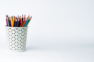 colorful pencils in a container with white background