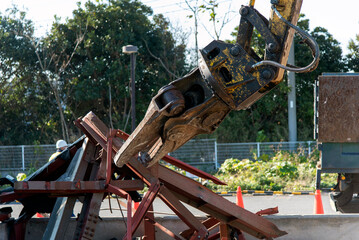 “Large nibbler” attachment for demolition machinery that picks up waste steel frames,...