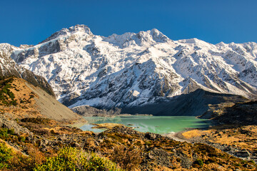 The vibrant aquamarine colour of Mueller Lake, walking the stunning Hooker Valley track, Aoraki Mt...