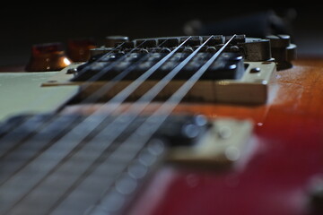 Fototapeta premium Electric guitar Fretboard closeup macro slider shot. Guitar pegs on a six-string guitar. musical instrument