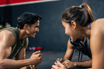 Group of young athlete male and female exercising together in fitness.