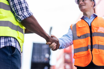 Caucasian businessman and African man worker working in container port