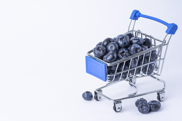 Ripe blueberries in a shopping cart close-up