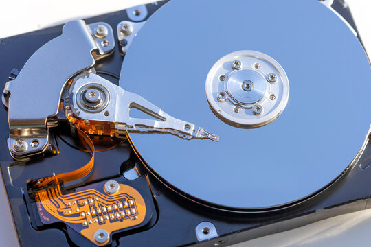 Disassembled hard drive from the computer, hdd with mirror effect. Opened hard drive from the computer hdd with mirror effects. Part of computer pc, laptop