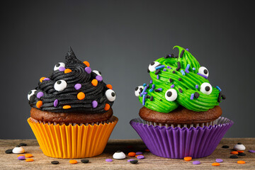 Cupcake on Halloween. Dessert on Halloween party. Chocolate muffin decorated with colored...