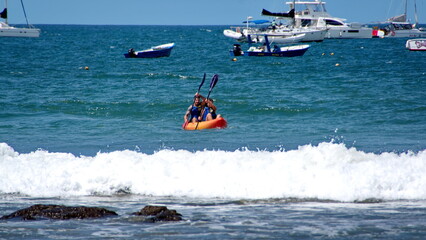 Kayaker in the water, off the beach, in Tamarindo, Costa Rica
