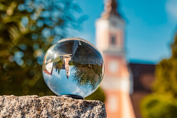 Crystal ball landscape shot with a church at Kuenzing, Bavaria, Germany