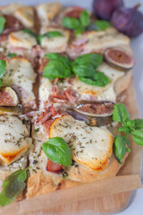 Fototapeta na wymiar tasty juicy pizza with figs on wooden background