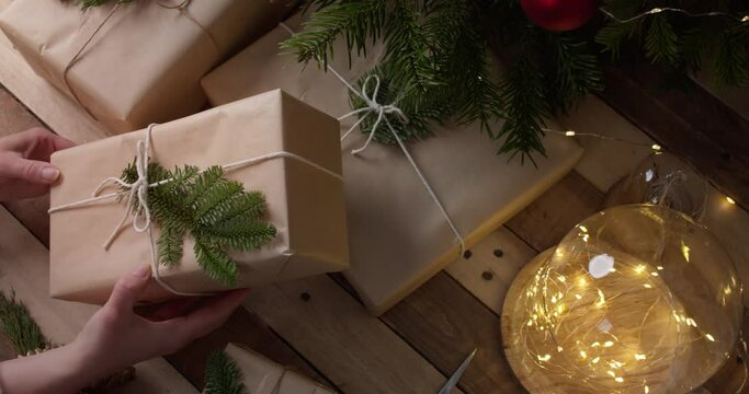 Christmas Present In Brown Paper Wrap, Eco Friendly Gift On Wooden Background