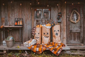 Photo zone for Halloween with festive handmade paraphernalia. Kraft paper bags painted with Jack...