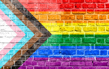 Progress LGBTQ rainbow flag waving in the wind at cloudy sky. Freedom and love concept. Pride...