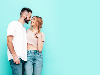 smiling beautiful woman and her handsome boyfriend. Happy cheerful family having tender moments near  wall in studio.Pure cheerful models hugging. Embracing each other. Cheerful and happy