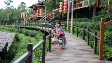 Fototapeta na wymiar Portrait of a girl children happy in nature.Tourists are happy on the landscape.Beautiful girl smiling in the green tea farm.