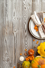 Thanksgiving day concept. Top view vertical photo of table setting plate napkin cutlery raw...